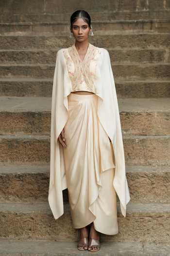 Eraaya by Ratika J_Beige Silk, Satin Shawl Neck Embroidered Cape Top With Skirt _at_Aza_Fashions
