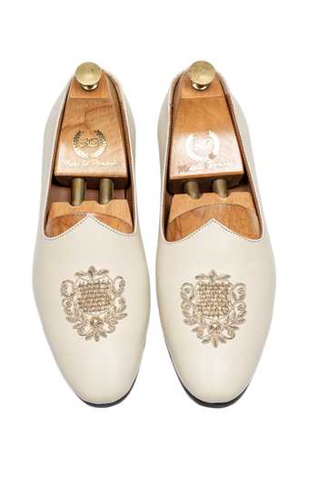 Shop_Domani_Cream Noor Crest Leather Slip On Loafers _at_Aza_Fashions