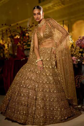 Seema Gujral_Gold Net Halter Neck Sequin Embroidered Bridal Lehenga Set _at_Aza_Fashions