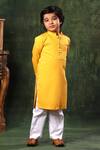 Shop Littlecheer Yellow Cotton Satin Pintuck Kurta And White Pyjama Set at Aza Fashions Shop_Littlecheer_Yellow Cotton Satin Pintuck Kurta And White Pyjama Set _at_Aza_Fashions