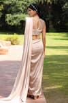 Shop_Tarini Vij_Gold Bremberg Lycra Satin And Net Pleated Stitched Saree With Pearl Blouse _at_Aza_Fashions