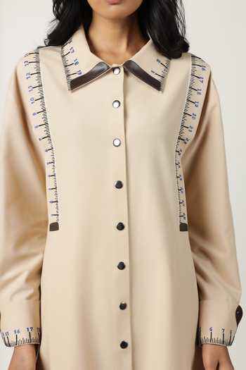 Shahin Mannan_Beige Poplin Embroidery Shawl Neck Measuring Tape Front Pleated Dress _at_Aza_Fashions