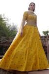 Buy_Keerthi Kadire_Yellow Raw Silk, Net Scoop Neck Embroidered Lehenga Set _at_Aza_Fashions