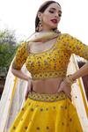 Shop_Keerthi Kadire_Yellow Raw Silk, Net Scoop Neck Embroidered Lehenga Set _at_Aza_Fashions