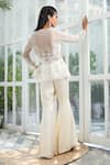 Shop_Kanj By Priyanka A Sakhuja_Ivory Silk Satin Sequin And Bead Work Illusion Luca Peplum Top & Pant Set _at_Aza_Fashions