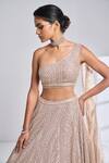 Seema Gujral_Gold Net Sequin, Pearl And Beads One Shoulder Blouse & Lehenga Set_at_Aza_Fashions