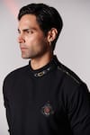 Shop_S&N by Shantnu Nikhil_Black Poly Blend Embroidered Crest Motif Asymmetric Draped Kurta_Online_at_Aza_Fashions