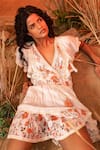 Label Reyya_White Rayon Lurex Floral Print, Crochet Lace And Sequin Work Surplice Tiered Dress _at_Aza_Fashions