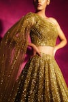 Vvani by Vani Vats_Gold Net Asymmetric Sequin Embroidered One Shoulder Lehenga Set _Online_at_Aza_Fashions