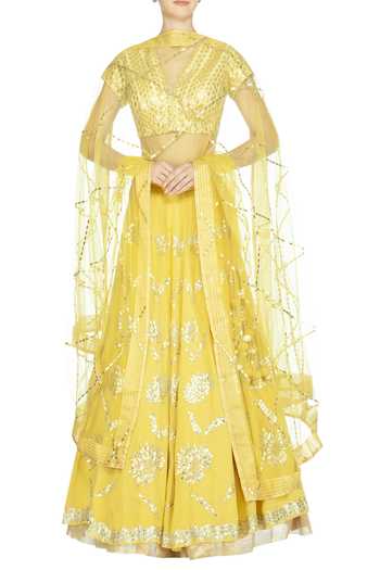 White lehenga with a Yellow Embroidered Dupatta.