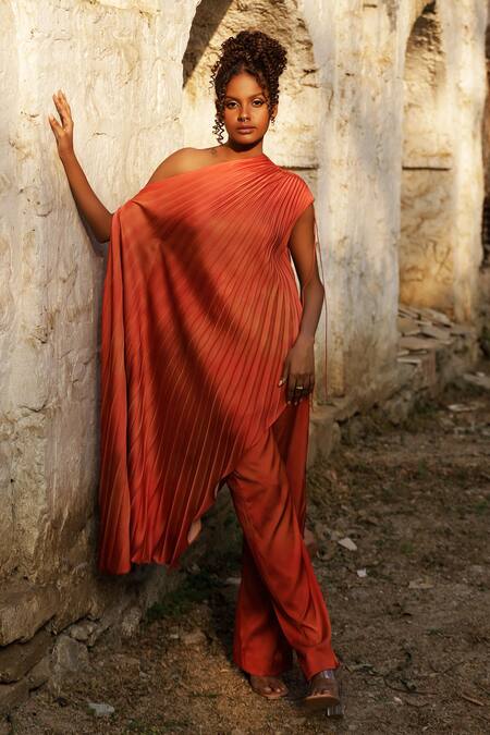 Buy Zwaan Orange Satin One Shoulder Pleated Asymmetric Top at Aza Fashions Buy_Zwaan_Orange Satin One Shoulder Pleated Asymmetric Top_at_Aza_Fashions