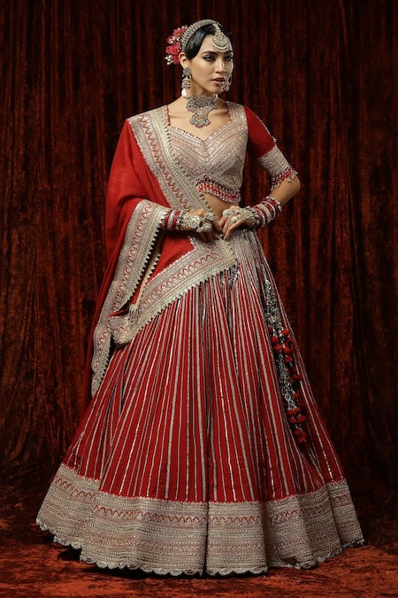 Red bridal royal motifs lehenga by Bhasin Brothers