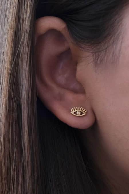 Shop_Anushka Jain Jewellery_Gold Plated Evil Eye Shaped Studs_at_Aza_Fashions
