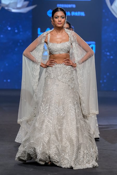 Premium Photo | A model in a silver lehenga with a floral design on the top.