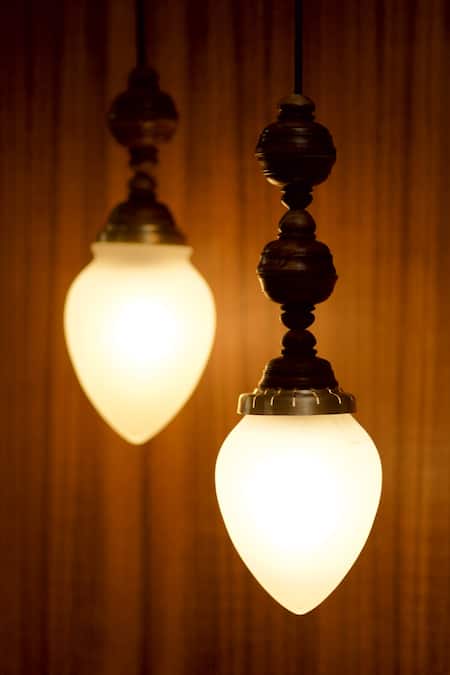 Buy Courtyard White Glass, Metal And Wood Carved Work Kalika Hanging Lamp - Single Pc at Aza Fashions Buy_Courtyard_White Glass, Metal And Wood Carved Work Kalika Hanging Lamp - Single Pc_at_Aza_Fashions