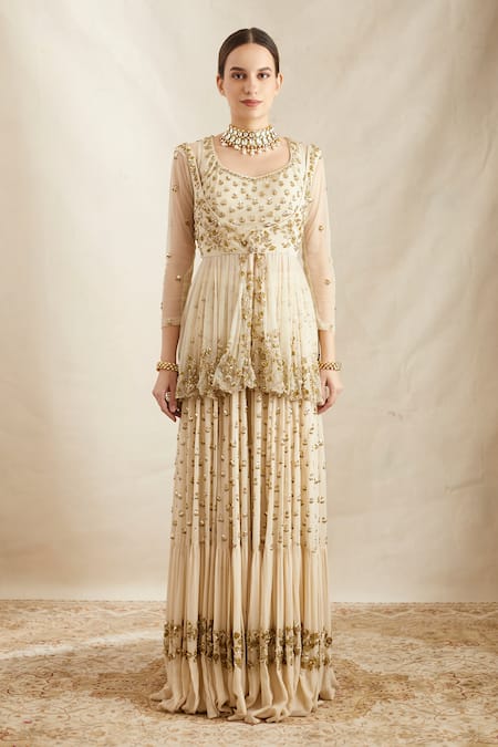 Astha Narang_Off White Net, Georgette Sequins, Floral Embroidered Peplum Jacket Sharara Set _at_Aza_Fashions