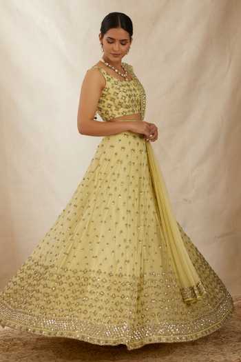 ASTHA NARANG_Yellow Net, Crepe, Nylon Embroidery, Cut Work, Flower Bridal Lehenga Set _at_Aza_Fashions