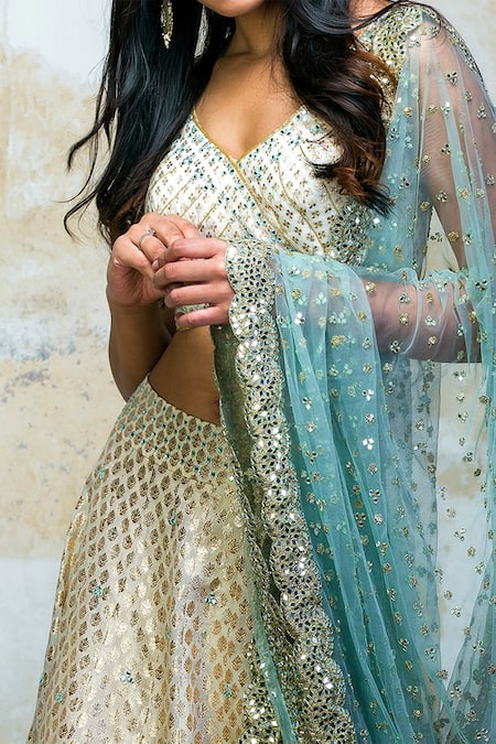 Izzumi Mehta Blue Lehenga And Blouse Brocade Dupatta Net V Neck Embroidered Bridal Set Online at Aza Fashions Izzumi Mehta_Blue Lehenga And Blouse Brocade Dupatta Net V Neck Embroidered Bridal Set _Online_at_Aza_Fashions