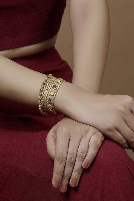 Mira By Radhika Jain Gold Plated Metal Carved Bracelet Online at Aza Fashions Mira By Radhika Jain_Gold Plated Metal Carved Bracelet_Online_at_Aza_Fashions