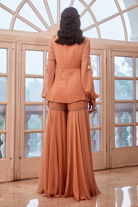 Shop Label Sanya Gulati Peach Round Embroidered Top And Sharara Set at Aza Fashions Shop_Label Sanya Gulati_Peach Round Embroidered Top And Sharara Set _at_Aza_Fashions