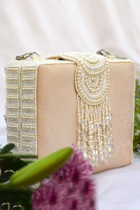 Shop Eena Beige Pearls, Beads, Crystals Erisha Tassel Clutch With Sling at Aza Fashions Shop_Eena_Beige Pearls, Beads, Crystals Erisha Tassel Clutch With Sling _at_Aza_Fashions