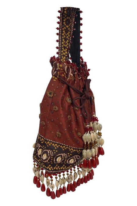 The Garnish Company Maroon Embroidered Mujal Bandhej Tassel Potli Bag Online at Aza Fashions The Garnish Company_Maroon Embroidered Mujal Bandhej Tassel Potli Bag _Online_at_Aza_Fashions