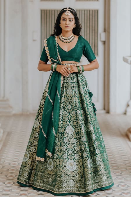 Draped in elegance, adorned in green. This lehenga whispers tales of grace  and style. 💚✨ #erlantz #vidhibysanjeela #newcollection #... | Instagram