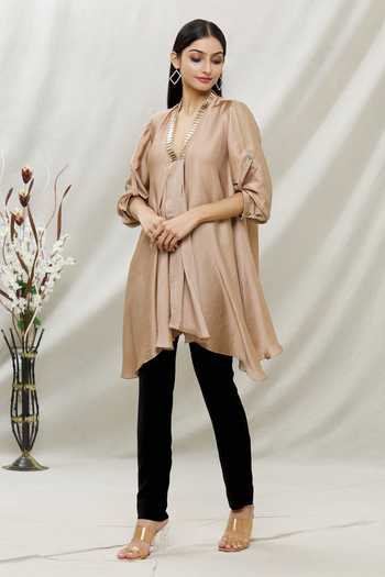 Buy Kommal Sood Beige Satin Embellished Stone V Neck Asymmetric Tunic at Aza Fashions Buy_Kommal Sood_Beige Satin Embellished Stone V Neck Asymmetric Tunic _at_Aza_Fashions