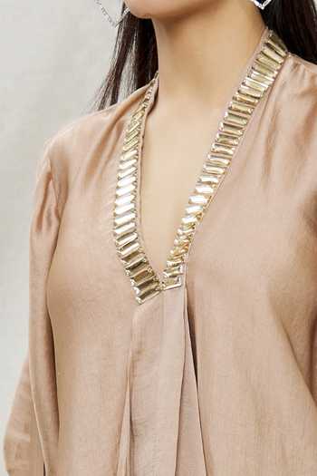 Kommal Sood Beige Satin Embellished Stone V Neck Asymmetric Tunic at Aza Fashions Kommal Sood_Beige Satin Embellished Stone V Neck Asymmetric Tunic _at_Aza_Fashions