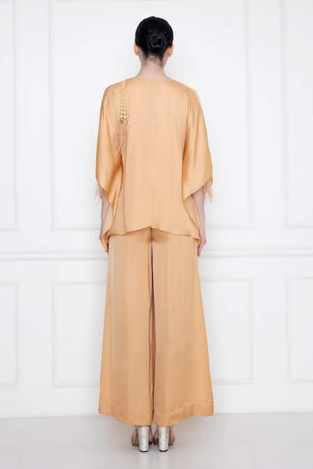 Shop Dilnaz Gold Cotton Satin V Neck Front Twist Kaftan Top With Jumpsuit at Aza Fashions Shop_Dilnaz_Gold Cotton Satin V Neck Front Twist Kaftan Top With Jumpsuit _at_Aza_Fashions
