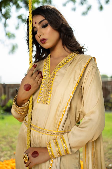 Buy The Home Affair Ivory Crepe Gota Patti, Sequins, Embroidery V-neck Draped Marodi Work Kurta Set Online at Aza Fashions Buy_The Home Affair_Ivory Crepe Gota Patti, Sequins, Embroidery V-neck Draped Marodi Work Kurta Set _Online_at_Aza_Fashions