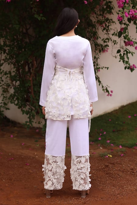 Shop Couché By Anandini Ivory Cotton, Tulle, Lycra Embroidery Split Wrap-over Applique Jacket And Pant Set at Aza Fashions Shop_Couché By Anandini_Ivory Cotton, Tulle, Lycra Embroidery Split Wrap-over Applique Jacket And Pant Set _at_Aza_Fashions