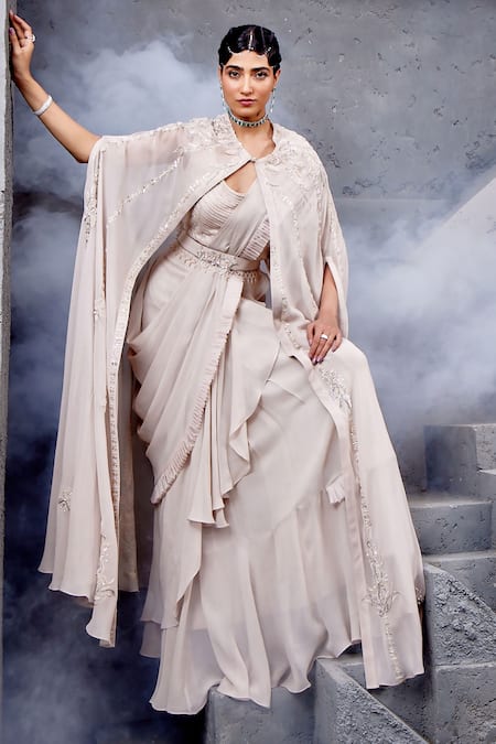 Shop Miku Kumar Ivory Georgette, Net Embroidery, Tassels Cape And Pre-draped Ruffle Saree Set Online at Aza Fashions Shop_Miku Kumar_Ivory Georgette, Net Embroidery, Tassels Cape And Pre-draped Ruffle Saree Set _Online_at_Aza_Fashions