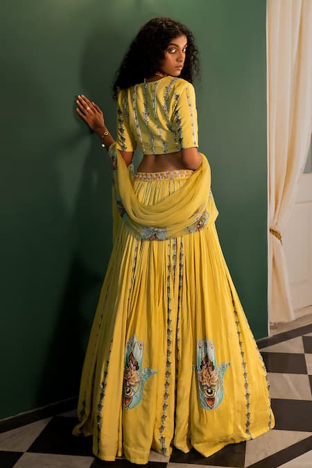 Shop 17:17 By Simmi Saboo Yellow Muslin Embroidered Cutdana V Neck Ariana Evil Eye Print Lehenga Set at Aza Fashions Shop_17:17 By Simmi Saboo_Yellow Muslin Embroidered Cutdana V Neck Ariana Evil Eye Print Lehenga Set _at_Aza_Fashions