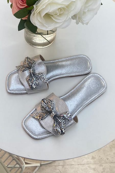 Shop Sana K luxurious Footwear Silver Swarovski Bow Embellished Sliders at Aza Fashions Shop_Sana K luxurious Footwear_Silver Swarovski Bow Embellished Sliders _at_Aza_Fashions