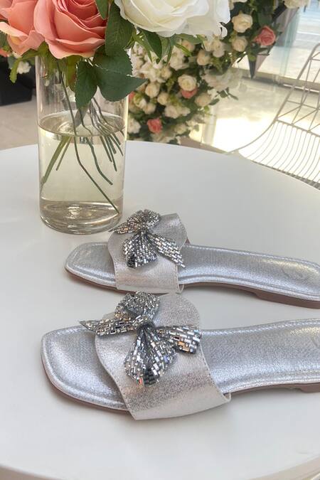 Buy Sana K luxurious Footwear Silver Swarovski Bow Embellished Sliders Online at Aza Fashions Buy_Sana K luxurious Footwear_Silver Swarovski Bow Embellished Sliders _Online_at_Aza_Fashions