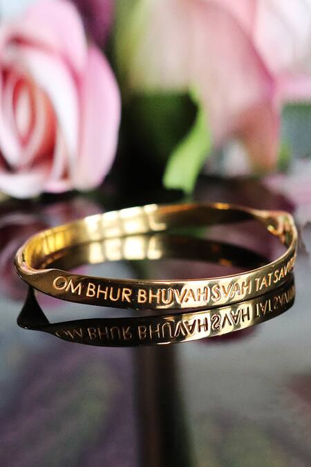Shop Eina Ahluwalia Gold Plated English Gayatri Mantra Bangle at Aza Fashions Shop_Eina Ahluwalia_Gold Plated English Gayatri Mantra Bangle_at_Aza_Fashions