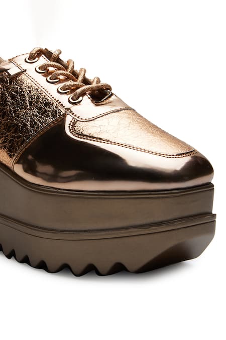 Buy Gold Metallic Mela Wedge Sneakers by Anaar Online at Aza Fashions.
