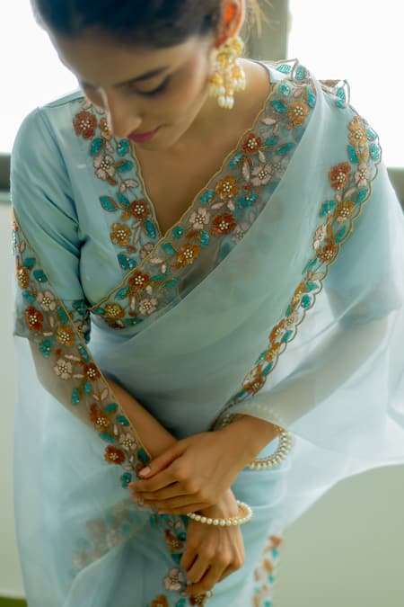 Peeli Dori Blue Silk Organza Hand Embroidered Floral Deep V Lotus Border Saree With Blouse at Aza Fashions Peeli Dori_Blue Silk Organza Hand Embroidered Floral Deep V Lotus Border Saree With Blouse _at_Aza_Fashions