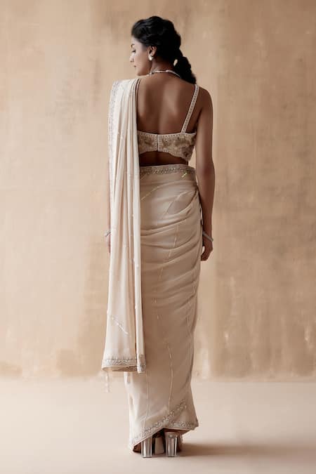 Shop Aman Takyar Ivory Georgette Pearls, Cut Work Asymmetric Border Embroidered Saree With Blouse at Aza Fashions Shop_Aman Takyar_Ivory Georgette Pearls, Cut Work Asymmetric Border Embroidered Saree With Blouse _at_Aza_Fashions