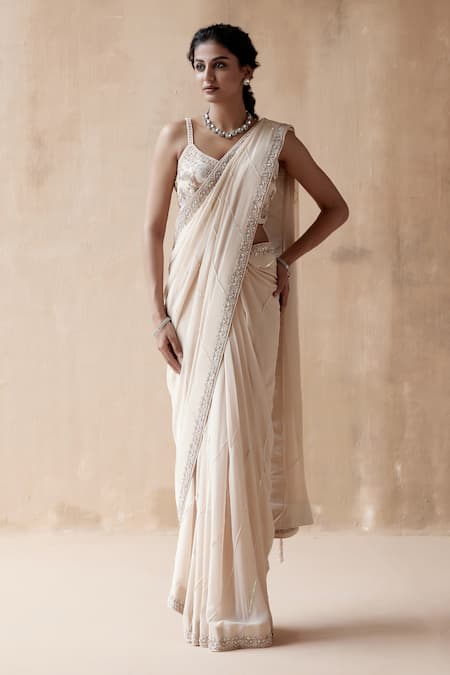 Aman Takyar Ivory Georgette Pearls, Cut Work Asymmetric Border Embroidered Saree With Blouse Online at Aza Fashions Aman Takyar_Ivory Georgette Pearls, Cut Work Asymmetric Border Embroidered Saree With Blouse _Online_at_Aza_Fashions