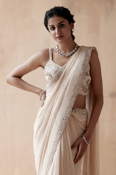 Shop Aman Takyar Ivory Georgette Pearls, Cut Work Asymmetric Border Embroidered Saree With Blouse Online at Aza Fashions Shop_Aman Takyar_Ivory Georgette Pearls, Cut Work Asymmetric Border Embroidered Saree With Blouse _Online_at_Aza_Fashions