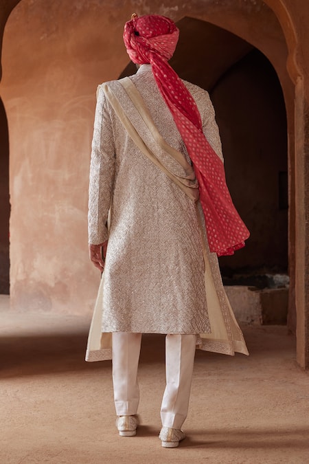 Shop Nitika Gujral Beige Silk, Cotton, Mohair Resham And Thread Embroidered Sherwani Trouser Set at Aza Fashions Shop_Nitika Gujral_Beige Silk, Cotton, Mohair Resham And Thread Embroidered Sherwani Trouser Set _at_Aza_Fashions