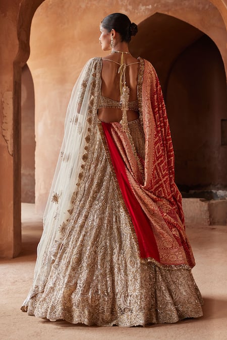 Shop_Nitika Gujral_Gold Net, Satin Crystals, Sequins V-neck Embroidered Bridal Lehenga Set _at_Aza_Fashions