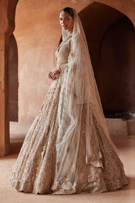 Shop_Nitika Gujral_Gold Net, Satin Crystals, Sequins V-neck Embroidered Bridal Lehenga Set _Online_at_Aza_Fashions