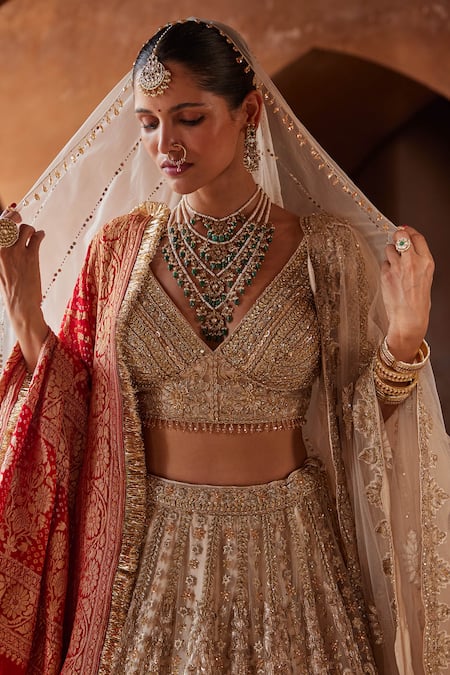 Nitika Gujral_Gold Net, Satin Crystals, Sequins V-neck Embroidered Bridal Lehenga Set _at_Aza_Fashions