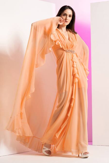 Shop Mandira Wirk Resort Peach Georgette Sequins, Beads, Stones V-neck Pleated Draped Cape Sleeve Dress Online at Aza Fashions Shop_Mandira Wirk Resort_Peach Georgette Sequins, Beads, Stones V-neck Pleated Draped Cape Sleeve Dress _Online_at_Aza_Fashions