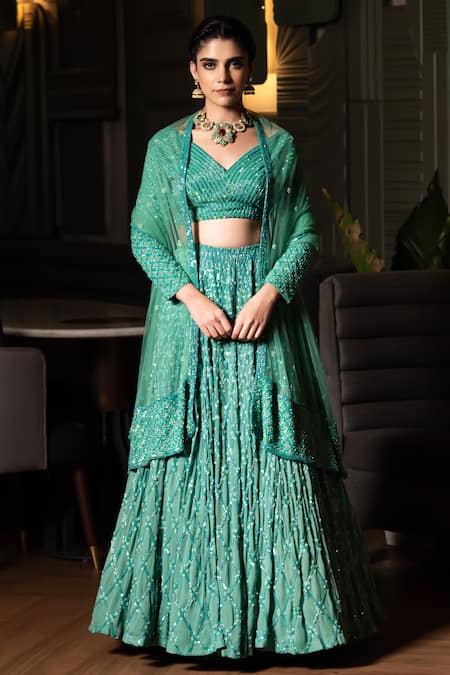 Shop Midushi Bajoria Green Georgette, Tulle Sequins, Cut Work V-neck Jaal Embellished Lehenga Set at Aza Fashions Shop_Midushi Bajoria_Green Georgette, Tulle Sequins, Cut Work V-neck Jaal Embellished Lehenga Set _at_Aza_Fashions