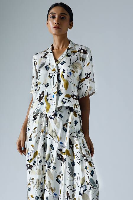 Klad White Satin Printed Floral Lapel Collar Asymmetrical Top And Skirt Set at Aza Fashions Klad_White Satin Printed Floral Lapel Collar Asymmetrical Top And Skirt Set_at_Aza_Fashions