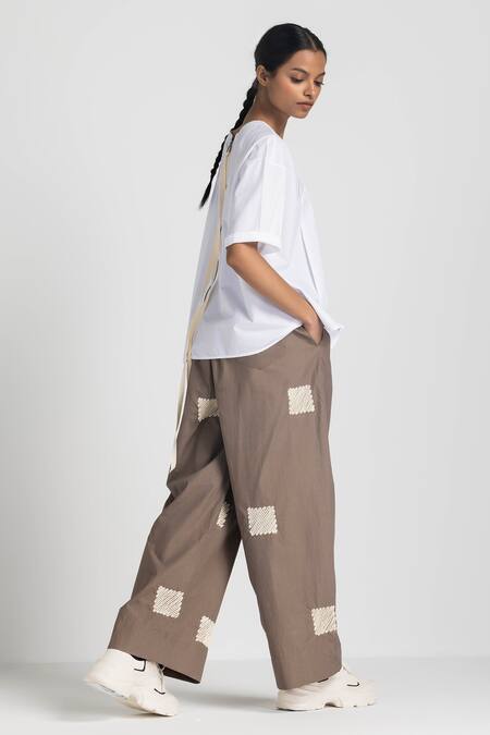 Shop Three White Poplin Embroidery Round Neck Asymmetric Pleated Top And Pant Set at Aza Fashions Shop_Three_White Poplin Embroidery Round Neck Asymmetric Pleated Top And Pant Set _at_Aza_Fashions